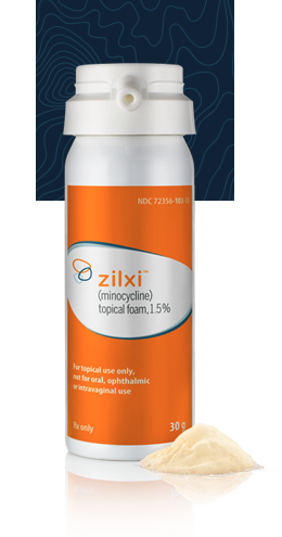 A bottle of foam with an orange Zilxi label stands in front of a textured blue background with a dollop of foam below it